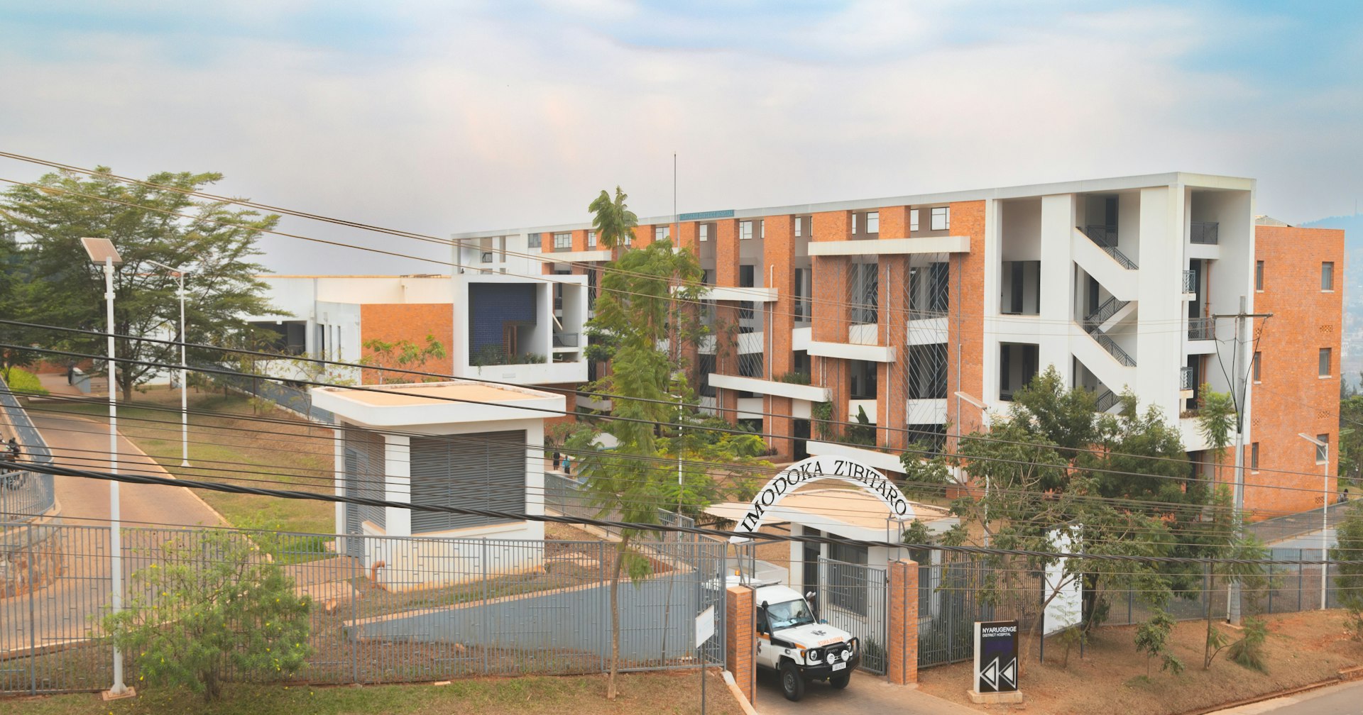 A street view of a building with cars parked in front of it